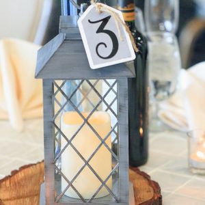 A glass of water and a candle on a table