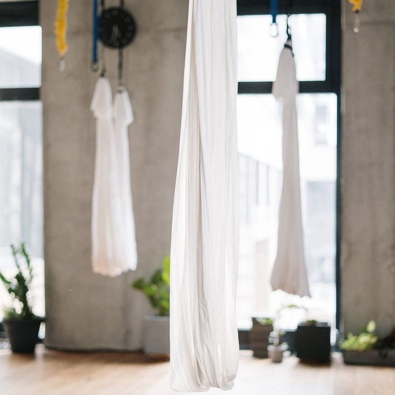 Minimalist yoga studio with wooden floor and large window