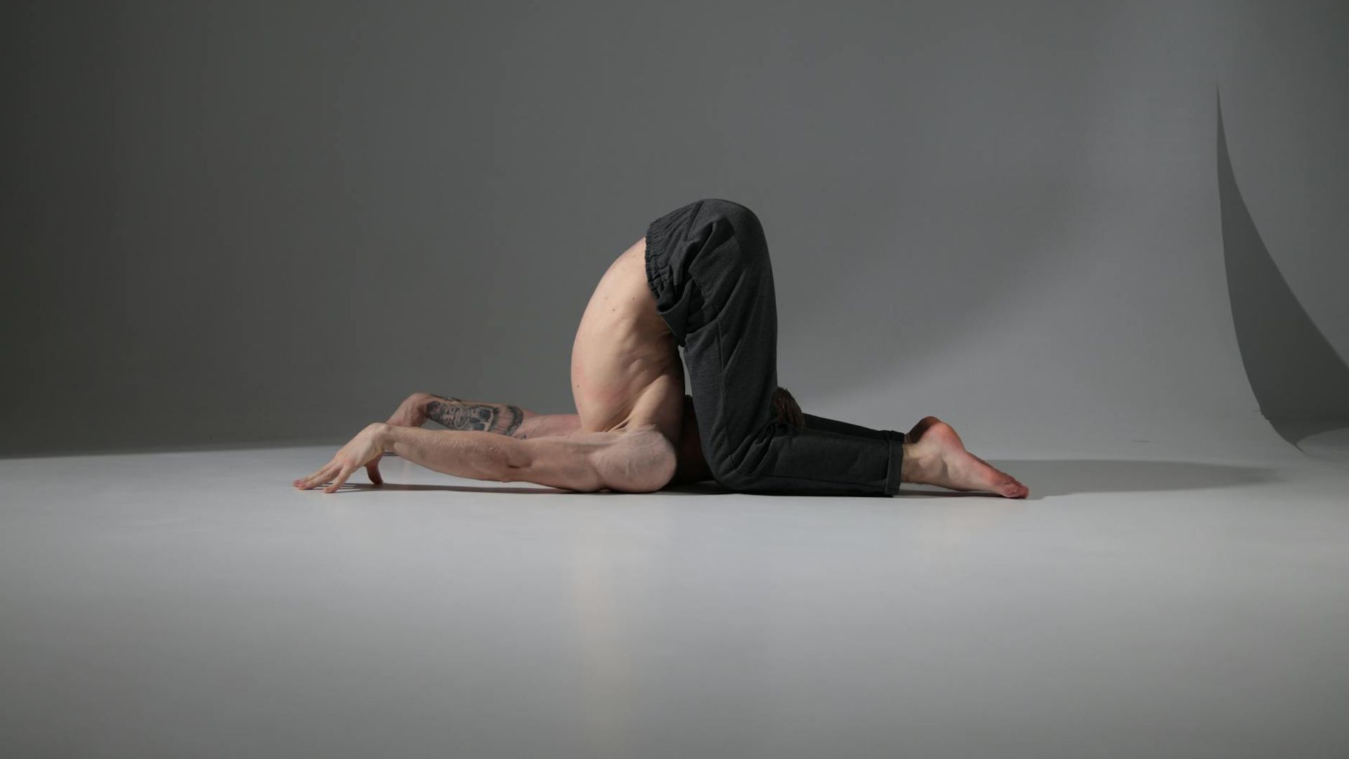 Serene yoga practitioner in a minimalistic studio environment